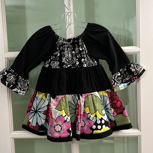 New handmade girls’ three tiered flannel dress in a size 18 months.
